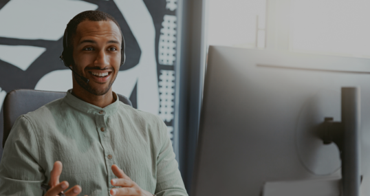 Handsome african businessman working computer while sitting in modern coworking