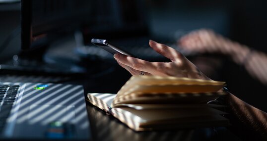 woman hands using smartphone, home office background, social media influencer