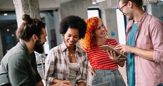 Young startup business people having fun, working and chatting at workplace office