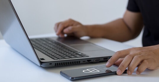 Cyber security concept. Business people type passwords and press the check button on a mobile smartphone application connect to the database via a data security system technology on display at office