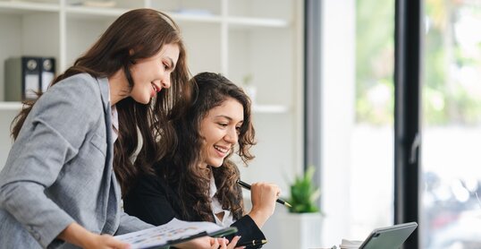 girl working together offer ideas to each other.happy young business colleagues working in the office