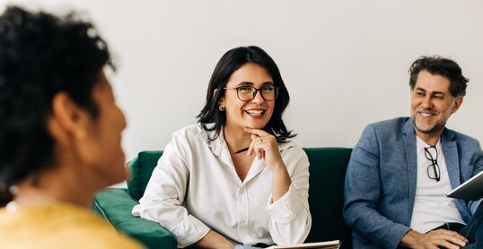 Diverse business people having a meeting with their colleague in an office